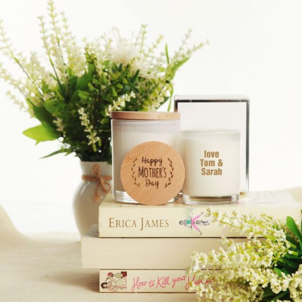 Vase, personalised soy candle and decorative books vignette.